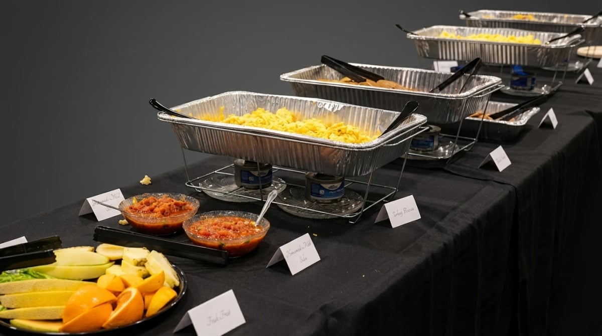 U.S. Egg catering spread — chafing dishes with scrambles, salsas, and fresh fruit