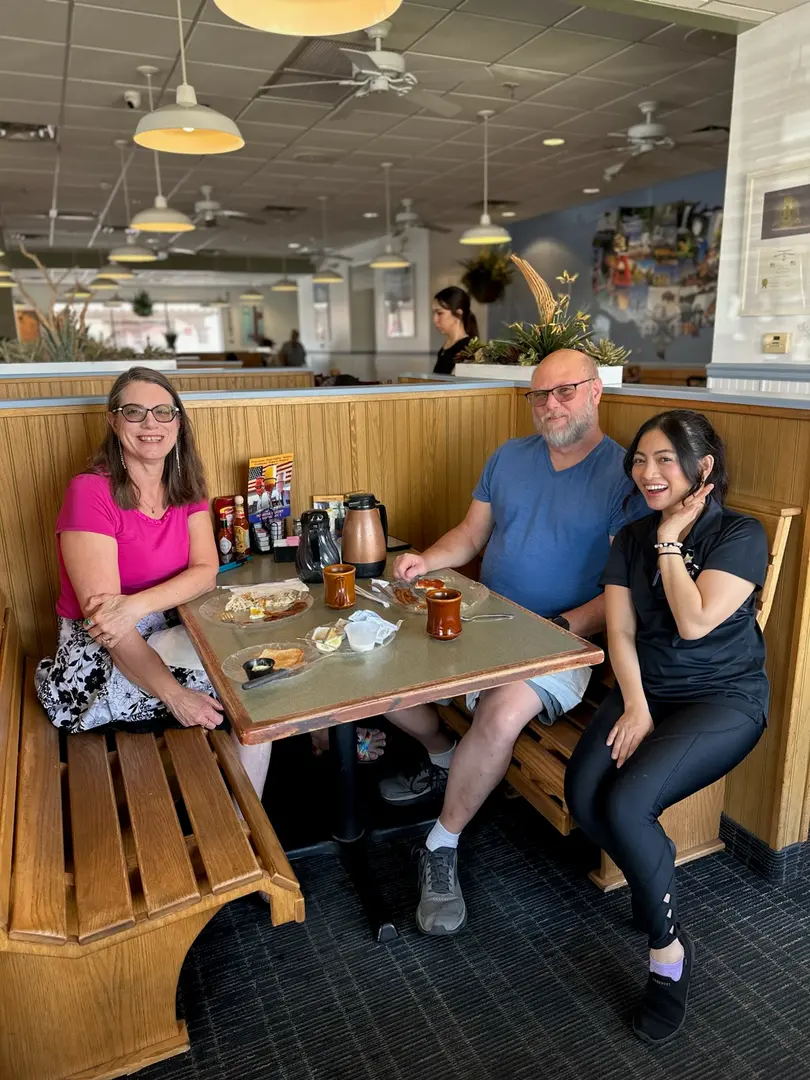 Happy group of diners enjoying brunch together at U.S. Egg