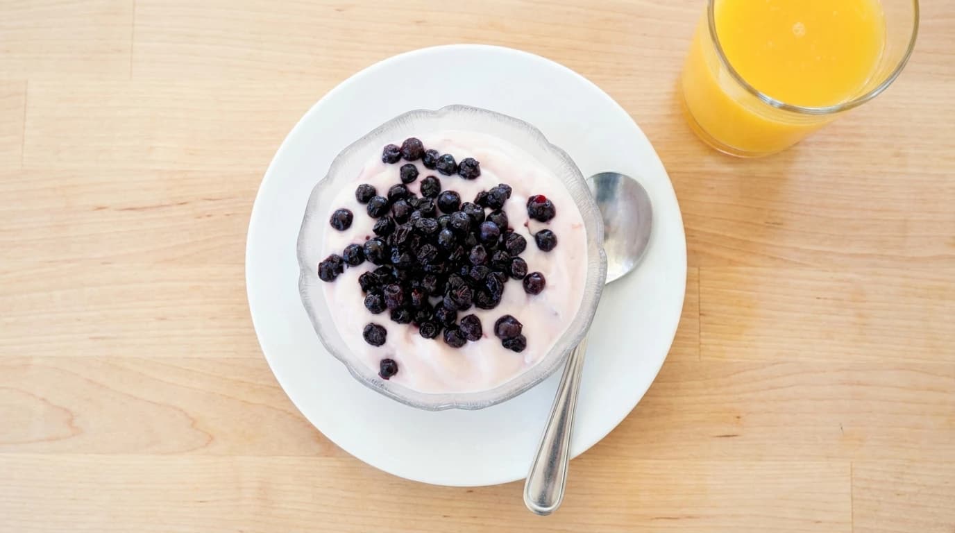Jr. / Sr. Yogurt Parfait - Bowl of strawberry yogurt topped w/ granola & Wild Maine Blueberries - U.S. Egg Breakfast & Lunch menu item